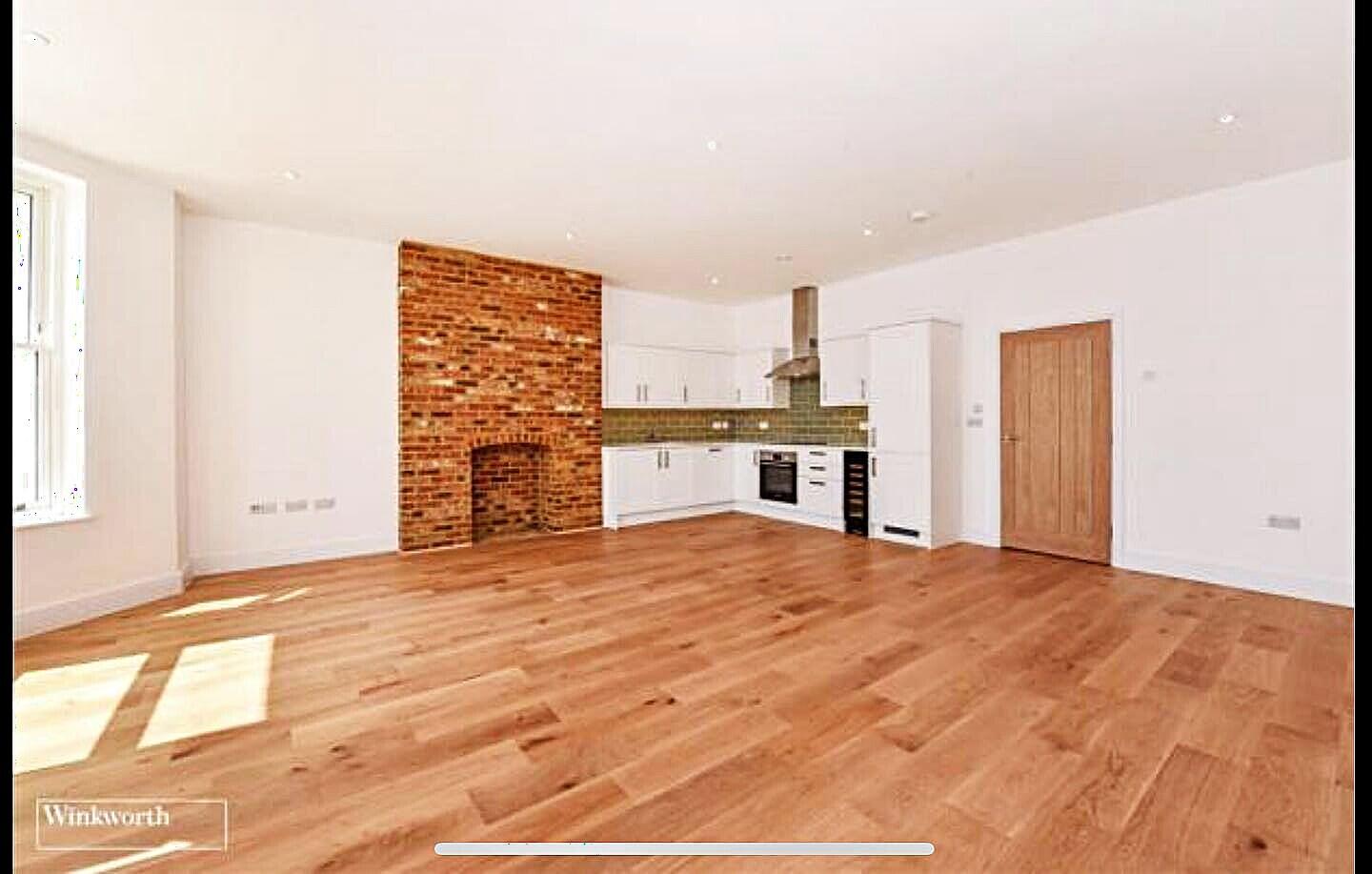 An open commercial room over a freshly installed timber floor