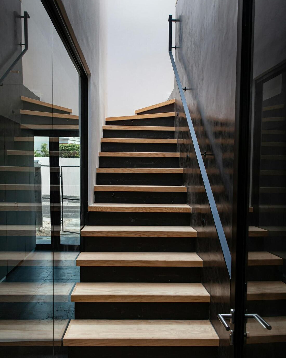 A stair flight with the nosing edge of each tread catching the light